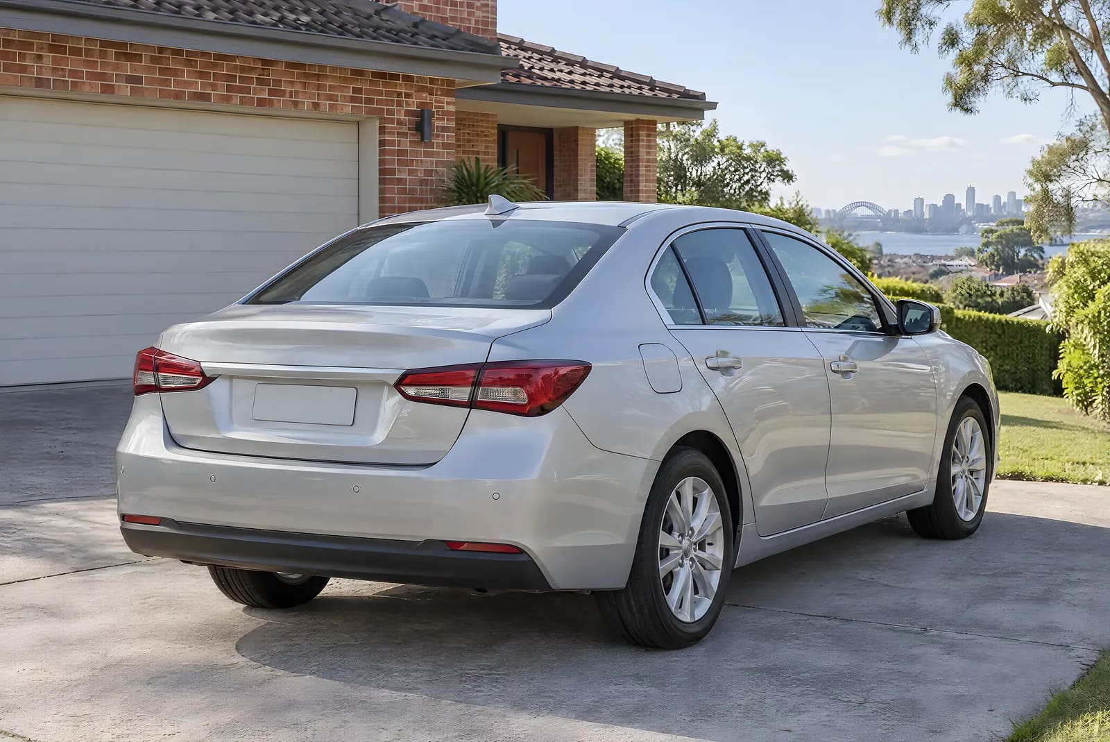The same silver sedan after repair, with straight rear panels and matched paint, parked in a suburban driveway